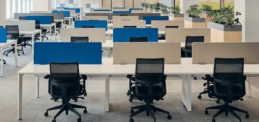 Modern open-plan office space featuring clean workstations, ergonomic chairs, and sanitized carpets provided by professional office cleaning services in Milwaukee, WI.