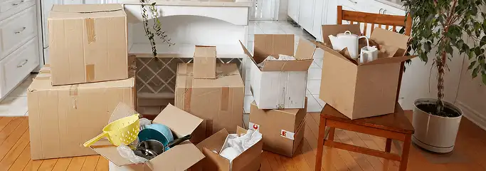 Packed moving boxes and household items in a kitchen before move-out or move-in cleaning, Milwaukee, WI.